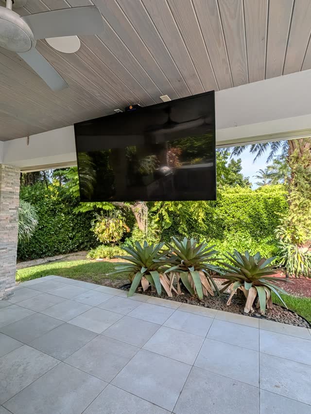 TV ceiling-mounted under a patio roof