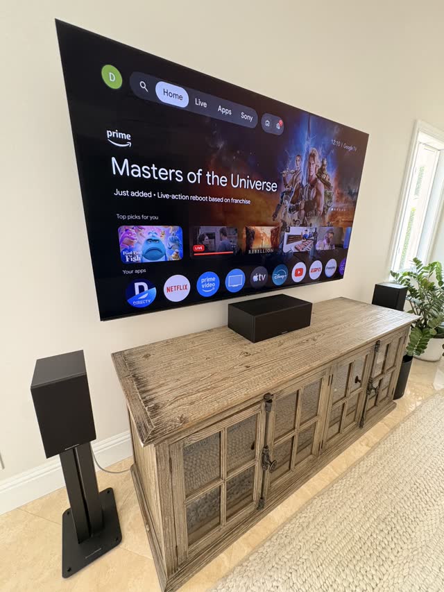 Large TV mounted over a rustic console