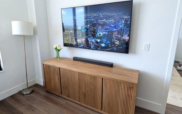 TV mounted over a wood console