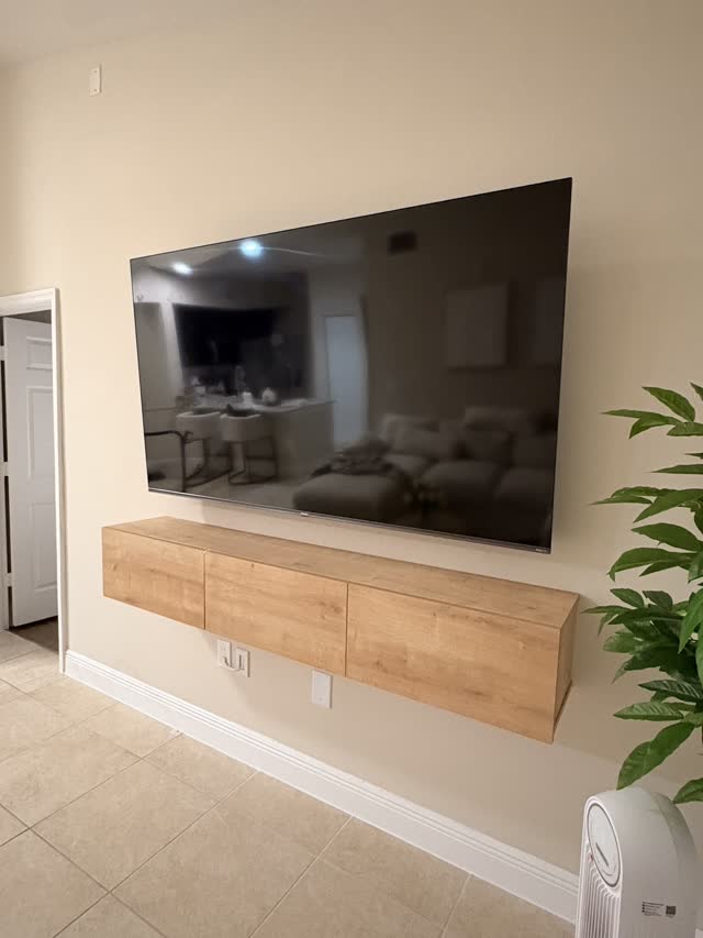 TV mounted over a floating media console