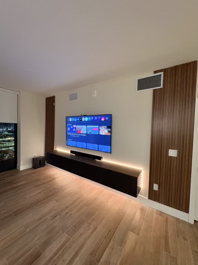 Wall-mounted TV with warm accent lighting